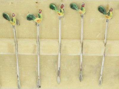 Lot 1079 - A set of twelve enamelled silver cocktail...