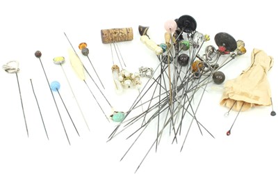 Lot 1219 - A collection of hat pins, including a 9ct gold...