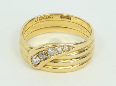 Lot 1234 - An 18ct gold and diamond snake ring, claw set...