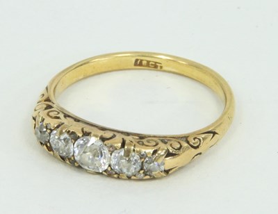 Lot 1247 - A five-stone diamond ring, the graduated...