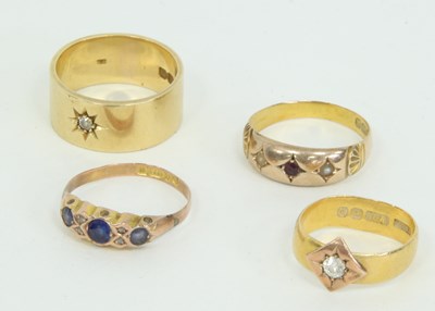 Lot 1260 - A 22ct gold ring set with a single diamond, an...