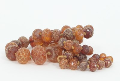 Lot 1263 - A single-row amber bead necklace, the faceted...