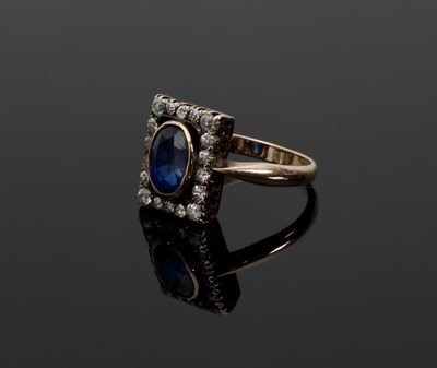 Lot 1284 - A sapphire and diamond ring, collet-set with...