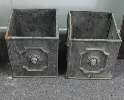 Lot 501 - A pair of lead cuboid planters with lion mask...