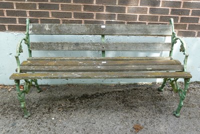 Lot 504 - A green painted garden seat with wooded slats...