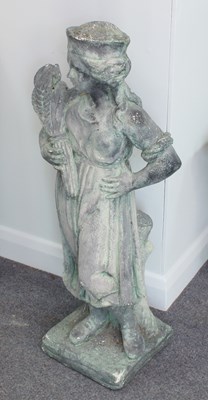 Lot 506 - A reconstituted stone figure of a girl holding...