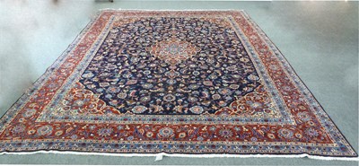 Lot 565 - A large Oriental carpet with central madder...