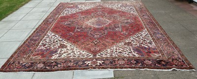 Lot 576 - A large Oriental rug with central blue...