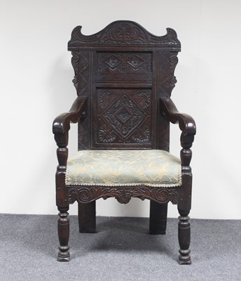 Lot 590 - An oak panel back armchair, part 17th Century,...