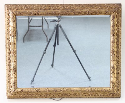 Lot 605 - A carved and gilded frame with bevelled mirror,...