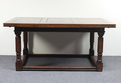 Lot 632 - An oak draw leaf dining table on turned legs...