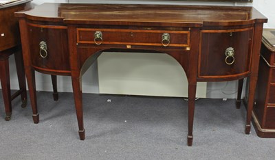 Lot 650 - A George III mahogany break bowfront sideboard,...