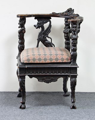 Lot 653 - An Anglo-Indian carved oak corner chair, on...