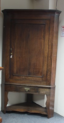 Lot 688 - An early 19th Century oak corner cupboard,...