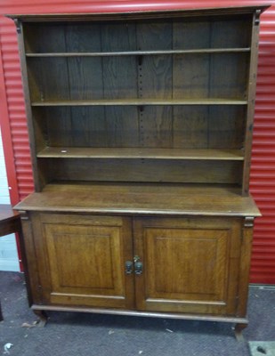 Lot 693 - A 19th Century oak dresser with shelves over...