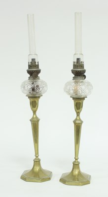 Lot 694 - A pair of brass candlestick oil lamps with cut...