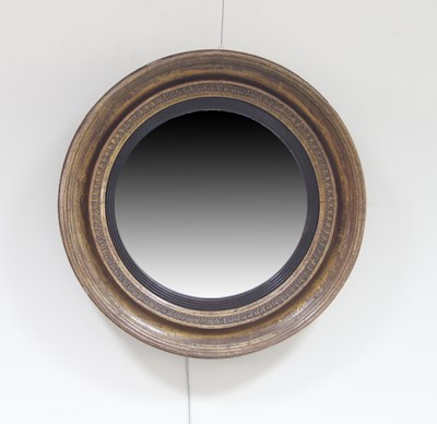 Lot 714 - A Regency convex mirror with ebonised reeded...