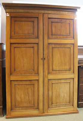 Lot 728 - A mahogany cupboard enclosed by panelled doors,...