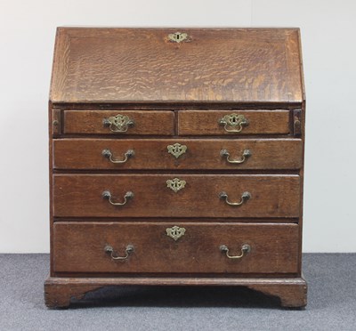 Lot 749 - A George III oak bureau, the fall above two...