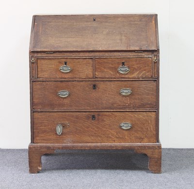 Lot 750 - An 18th Century oak bureau, the fall above two...