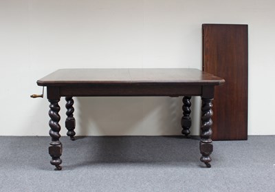 Lot 753 - An oak extending dining table, with two extra...