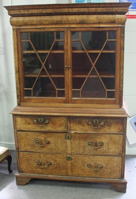 Lot 801 - A walnut cabinet, the upper section enclosed...