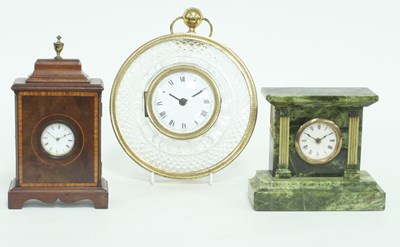 Lot 848 - A cartel clock in a glass case, the white...