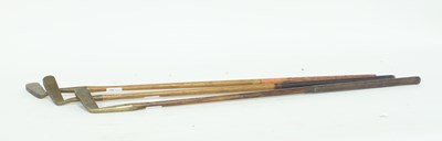 Lot 886 - Three hickory shafted brass bladed golf putters