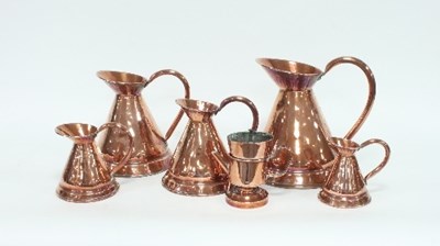 Lot 62 - A graduated set of five copper rum jugs,...