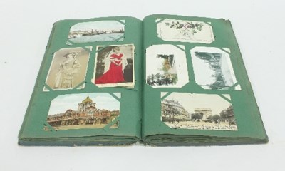 Lot 68 - An Edwardian postcard album, the inner cover...