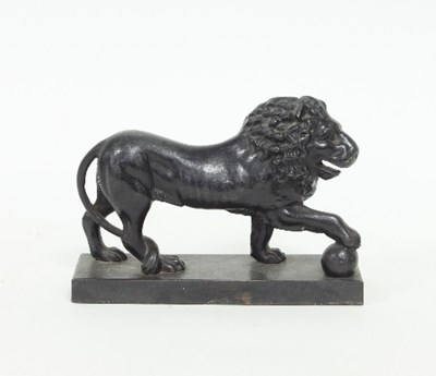 Lot 74 - An iron door-stop modelled as a standing lion...