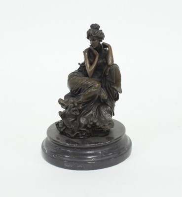 Lot 84 - A bronzed metal figure of a seated lady...