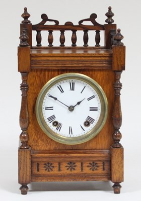 Lot 101 - An Aesthetic movement oak mantel clock, with...