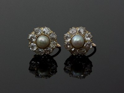 Lot 401 - A pair of pearl and diamond ear clips, the...