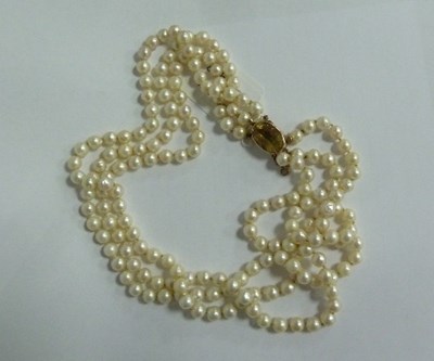 Lot 403 - A three-row pearl necklace with oval citrine...