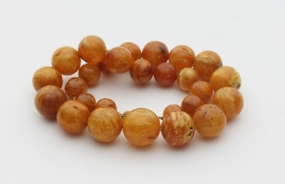 Lot 440 - A Baltic amber necklace, of twenty-seven...