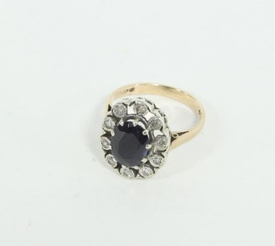 Lot 459 - A sapphire and diamond cluster ring, the...