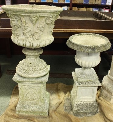 Lot 506 - A reconstituted stone urn, the sides decorated...