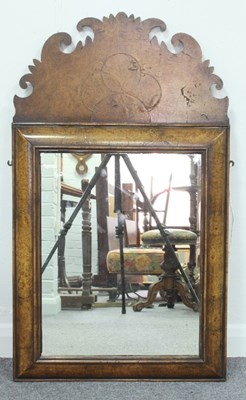 Lot 527 - A walnut mirror, the fret work cresting and...