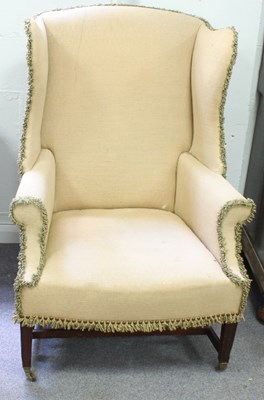 Lot 552 - A George III style mahogany wing armchair,...