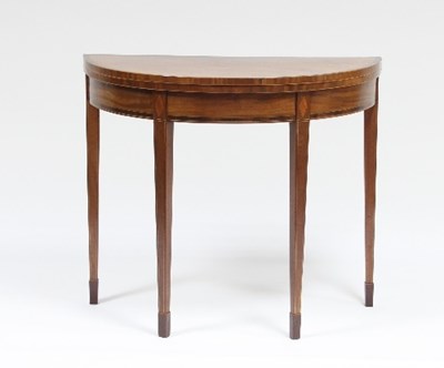 Lot 557 - A George III mahogany semi-circular card table...