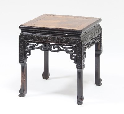 Lot 562 - A Chinese hardwood stand, the square top on...