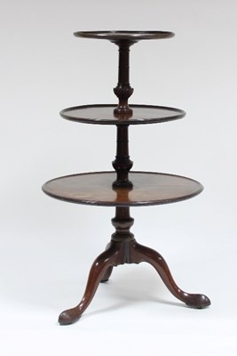 Lot 565 - A George III mahogany three-tier dumb waiter,...