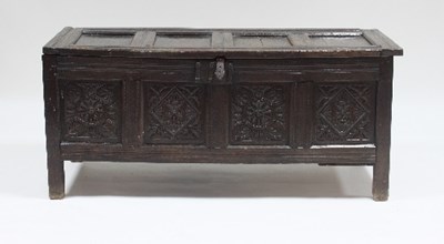 Lot 591 - A 17th Century oak chest, the four-panel top...