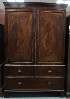 Lot 626 - A George III mahogany linen press, the oval...