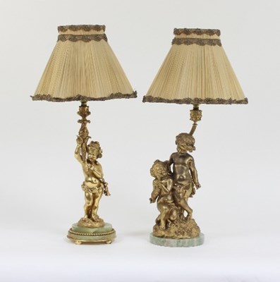 Lot 663 - Two near matching ormolu lamps, each cast as...