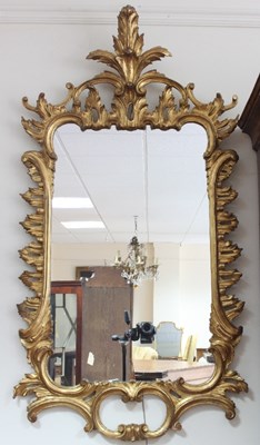 Lot 671 - A George III style carved and gilded mirror in...