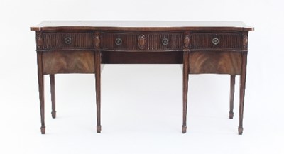 Lot 678 - A mahogany serpentine sideboard with fluted...