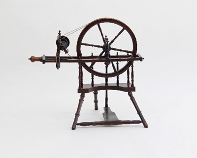 Lot 686 - A turned wooden spinning wheel on turned legs,...