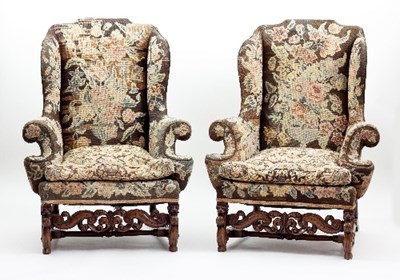 Lot 693 - A pair of Carolean style walnut wing armchairs,...